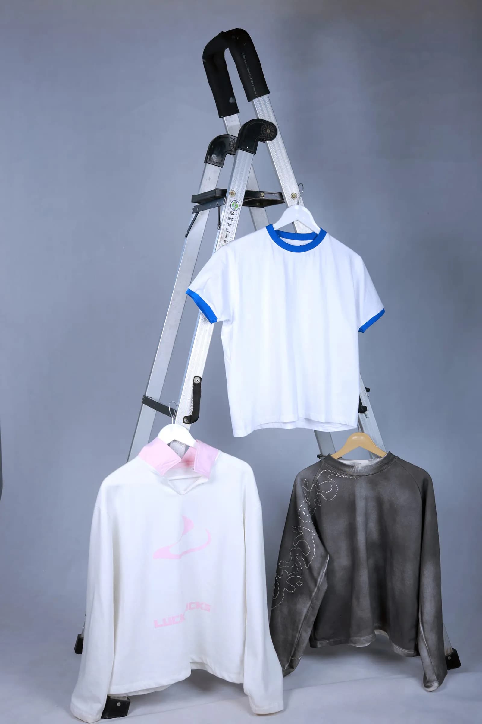 All three Drop 01 pieces on hangers on a studio ladder