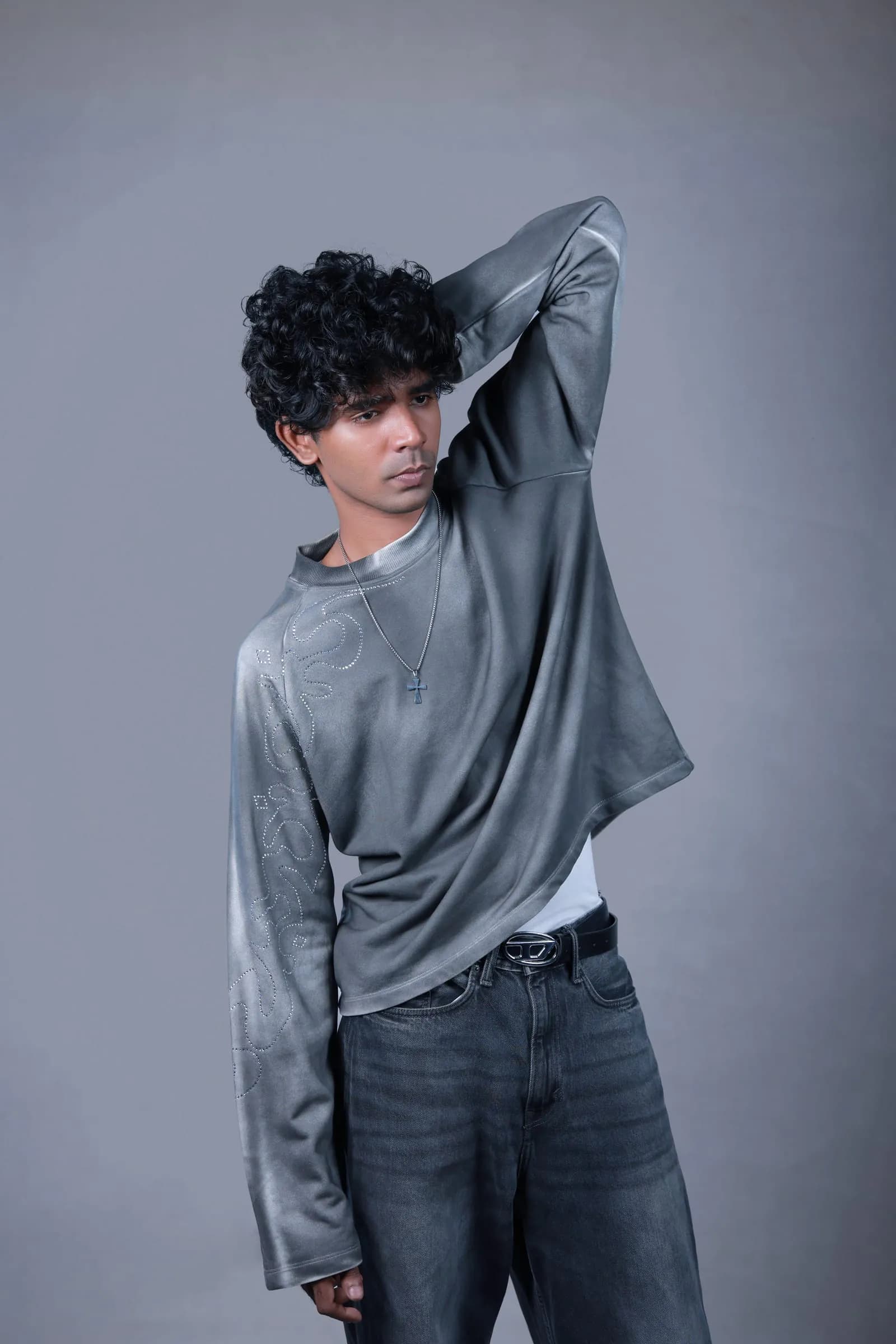 Model wearing the grey long-sleeve with dark denim