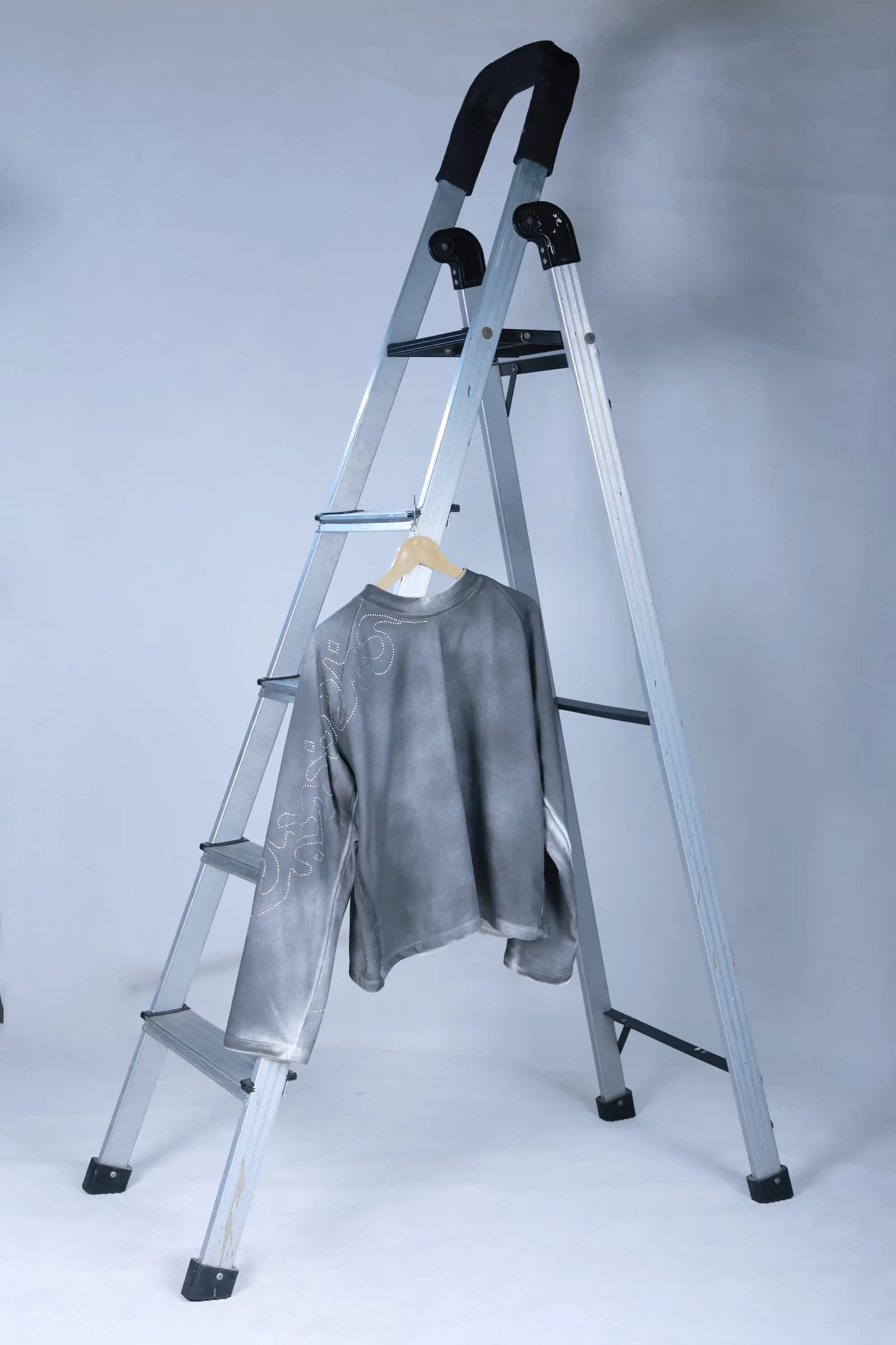 Grey long-sleeve on a hanger showing the oversized fit