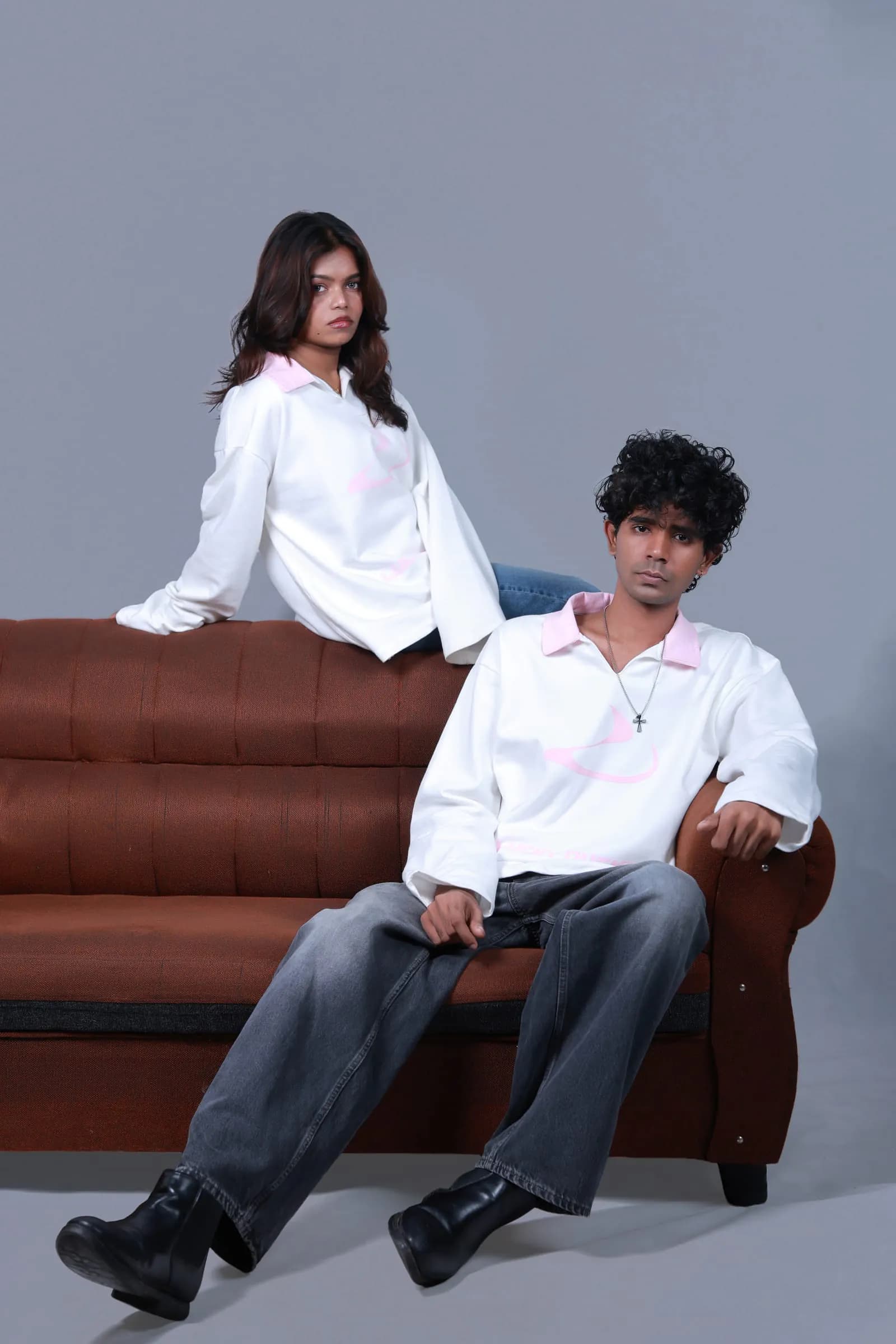 Two models in the Signature Long-Sleeve on a leather sofa