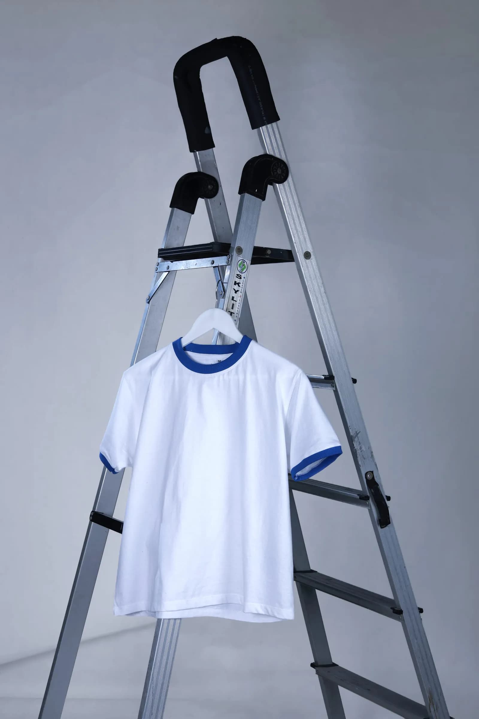 Ringer Baby Tee on a hanger showing the blue neckline and sleeve trims